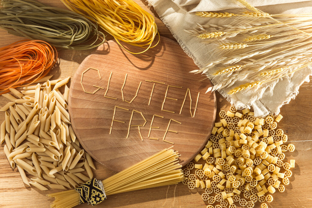 Gluten free food. Various pasta on wooden background from top view. Healthy and diet concept.