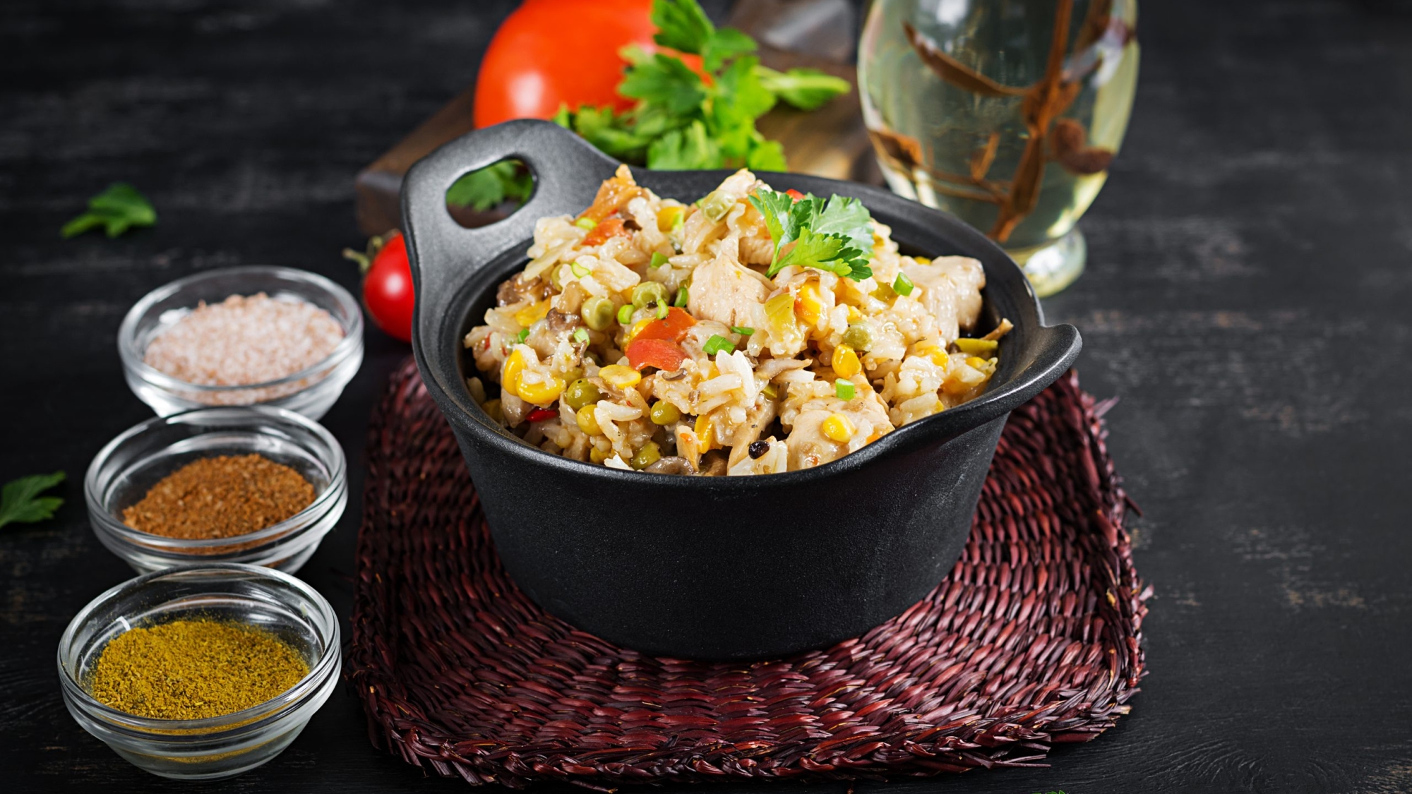 Rice with chicken and vegetables in bowl on dark background. Diet menu. Lunch.